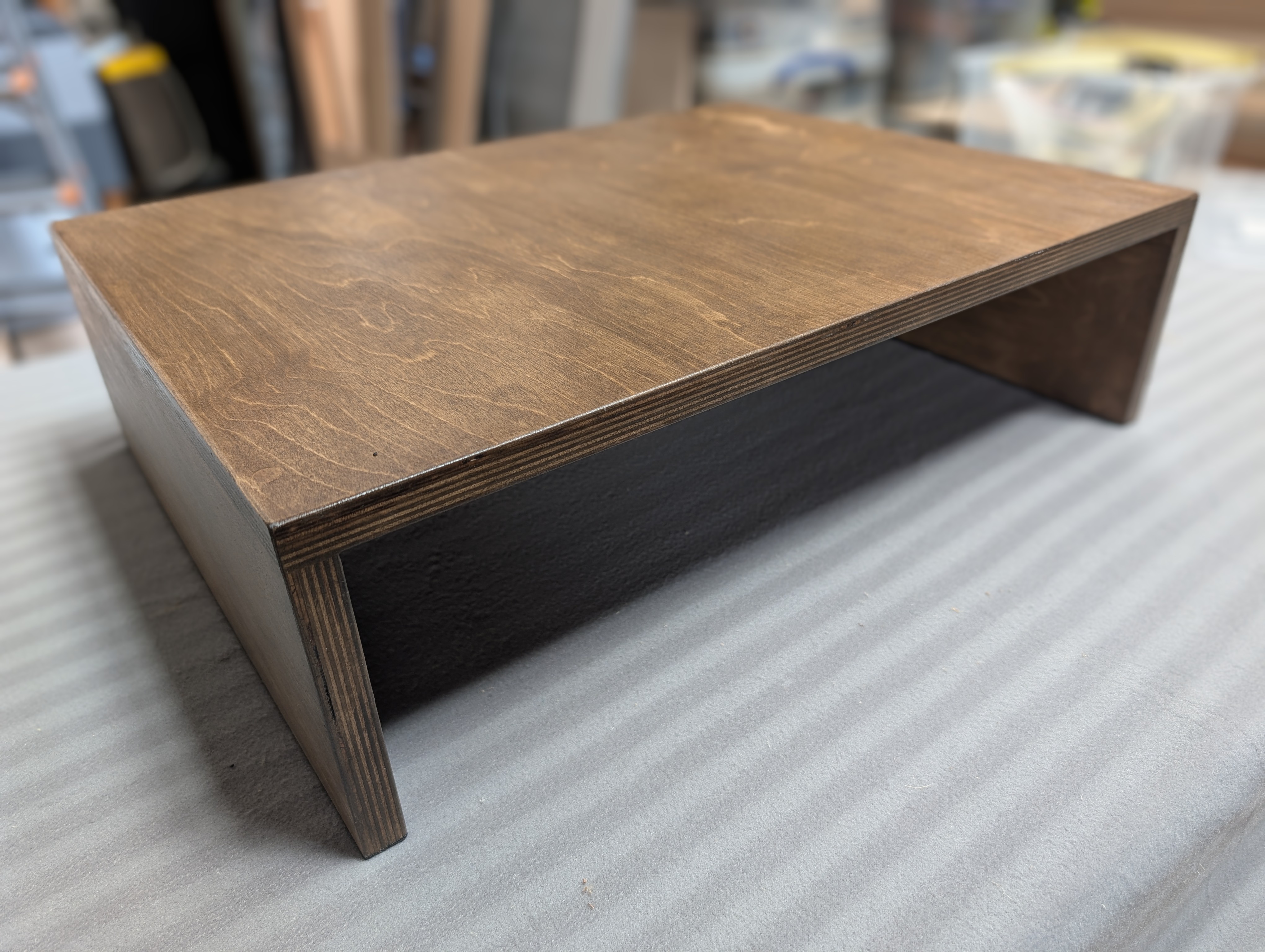 Dark stained turntable riser.