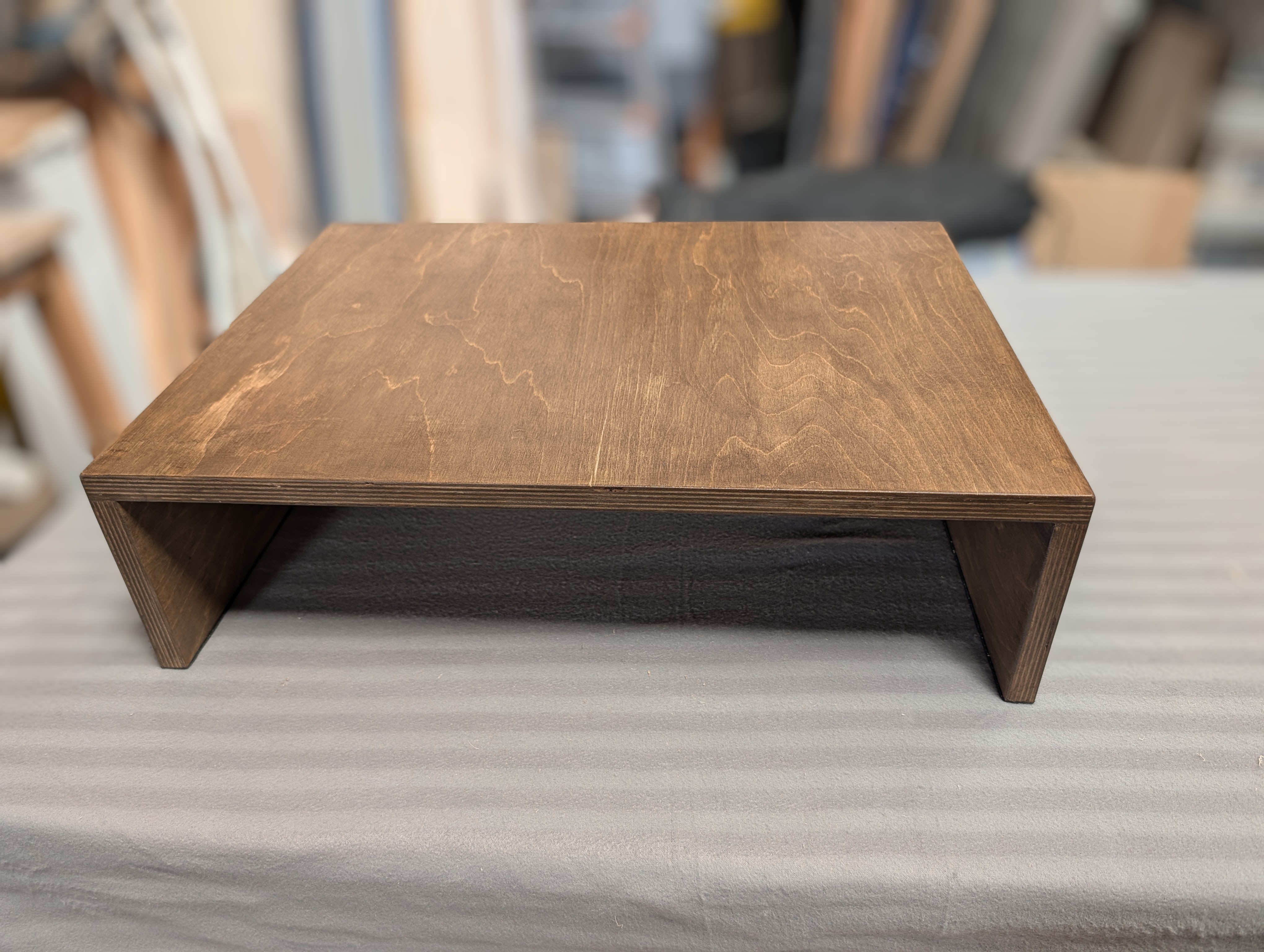 Dark stained turntable riser.